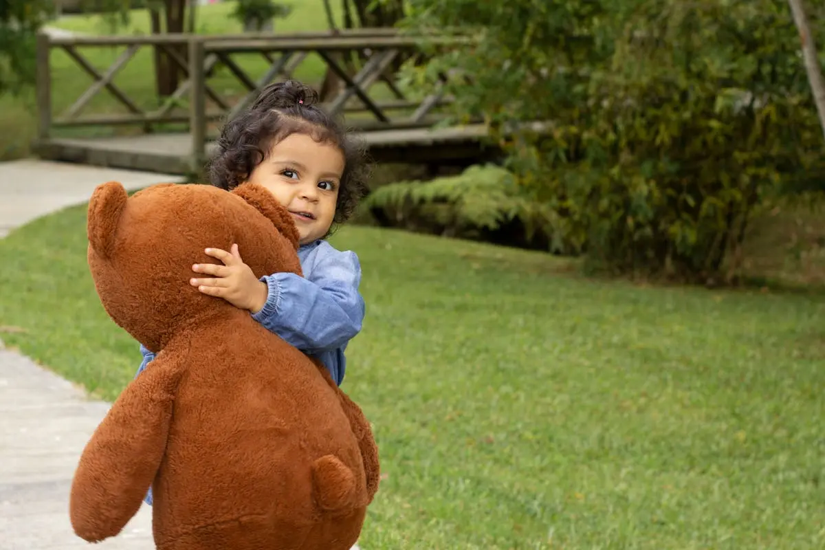 Little Girl with a Teddy Bear that's a cute stuffed animal