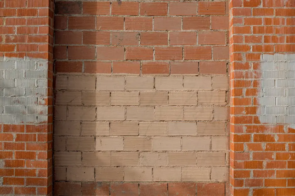 Close-up of a mixed red and beige brick wall, showcasing textured brickwork pattern.