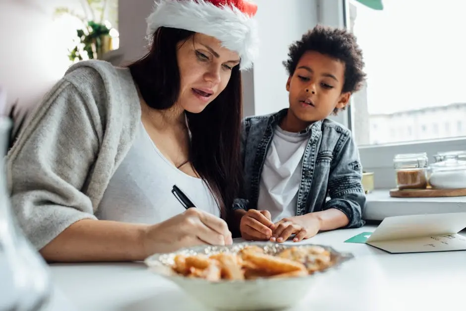 A mother and child writing Christmas cards, creating a festive atmosphere indoors.