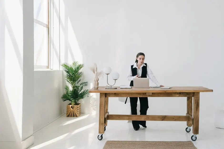 Woman in Black Vest Standing by the Brown Wooden Table