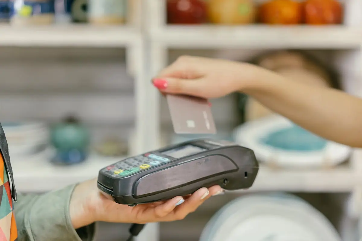 A PERSON HOLDING A PAYMENT TERMINAL