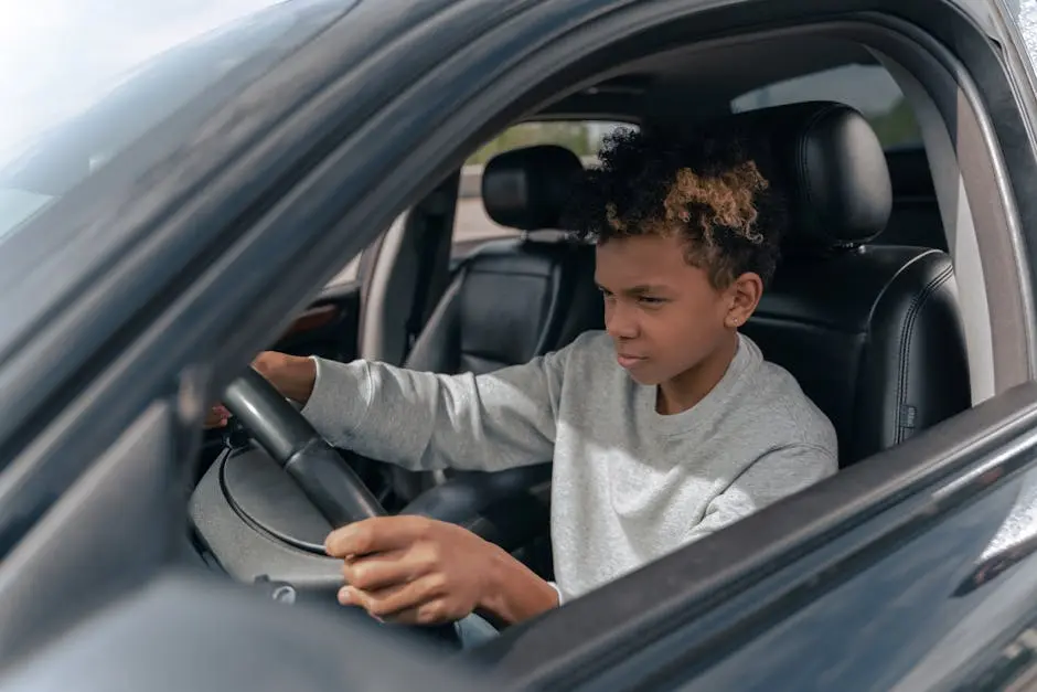 Boy in Gray Sweater Driving Car