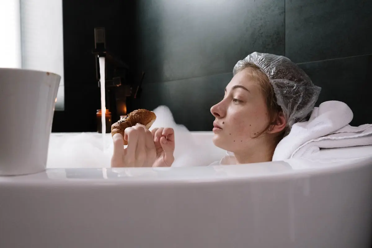 A Woman in Bathtub Holding a Bread