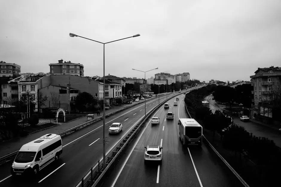 Black and white photo of highway with cars on it