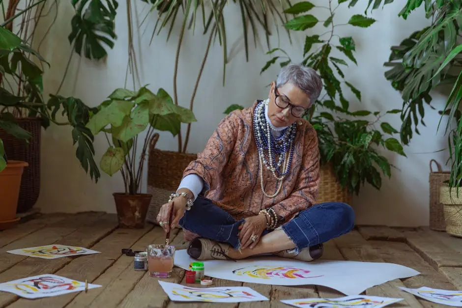 Photo Of Woman Sitting On Floor While Painting