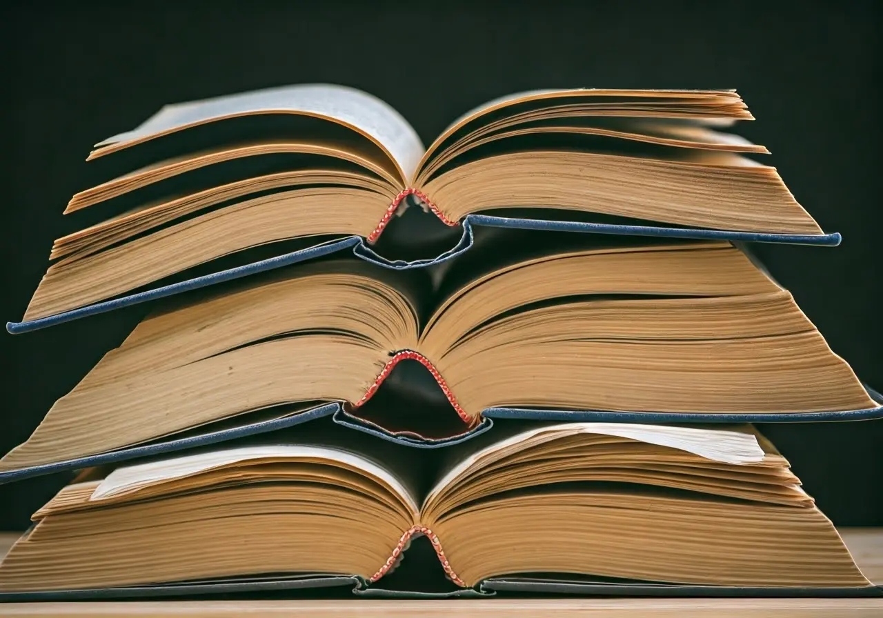 A stack of open textbooks with highlighted sections. 35mm stock photo