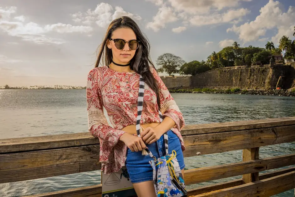 Fashionable woman with sunglasses poses on a scenic pier in San Juan, Puerto Rico.