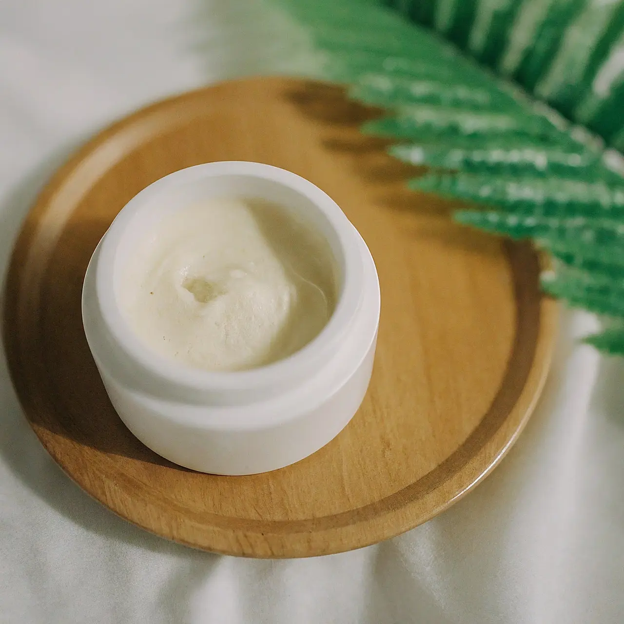 A jar of anti-aging cream with natural ingredients on display. 35mm stock photo