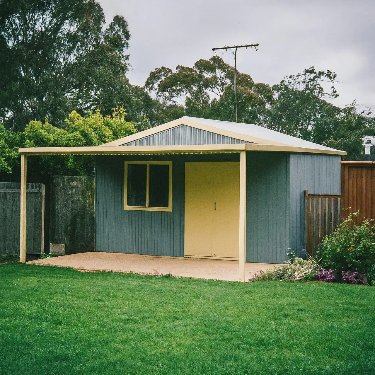 Colorbond shed in a well-landscaped backyard. 35mm stock photo