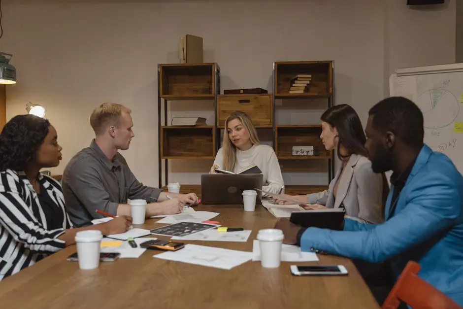 Business team discussing strategies in a modern office setting, focusing on collaboration.