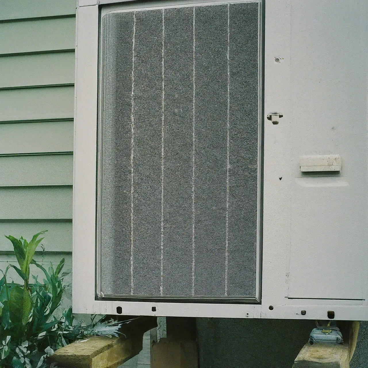 Close-up of HVAC unit outside a suburban house. 35mm stock photo