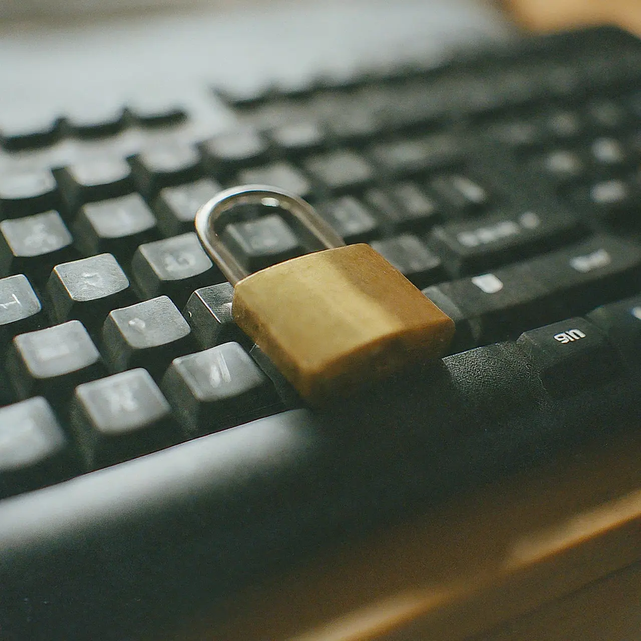 A computer keyboard with a padlock on top. 35mm stock photo