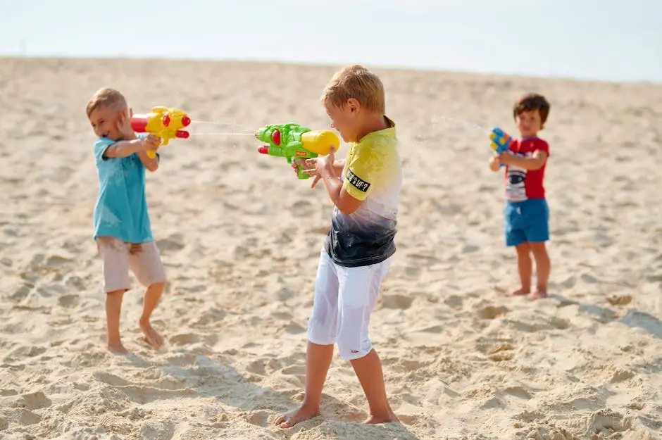 Children Playing Water Guns on the Sand