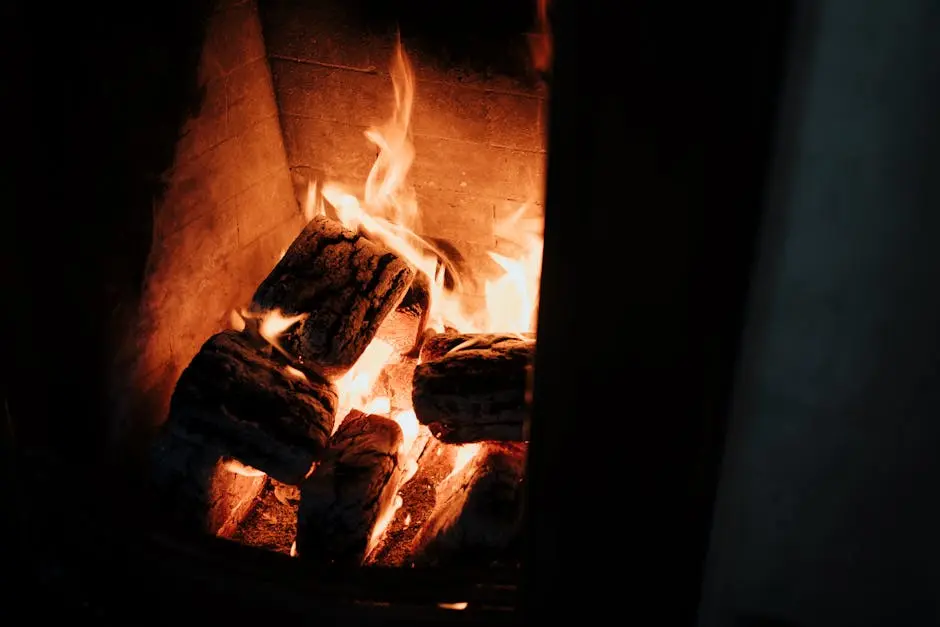 Close-up of burning logs in a warm, cozy fireplace, perfect for a relaxing at-home ambiance.