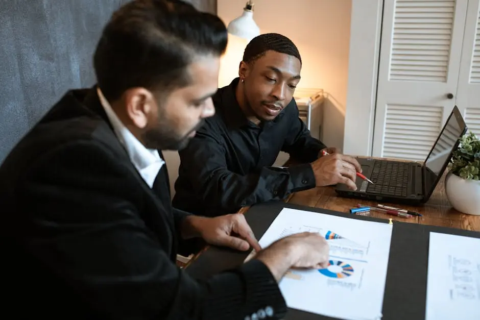 Two professionals discussing charts and graphs in a contemporary office.