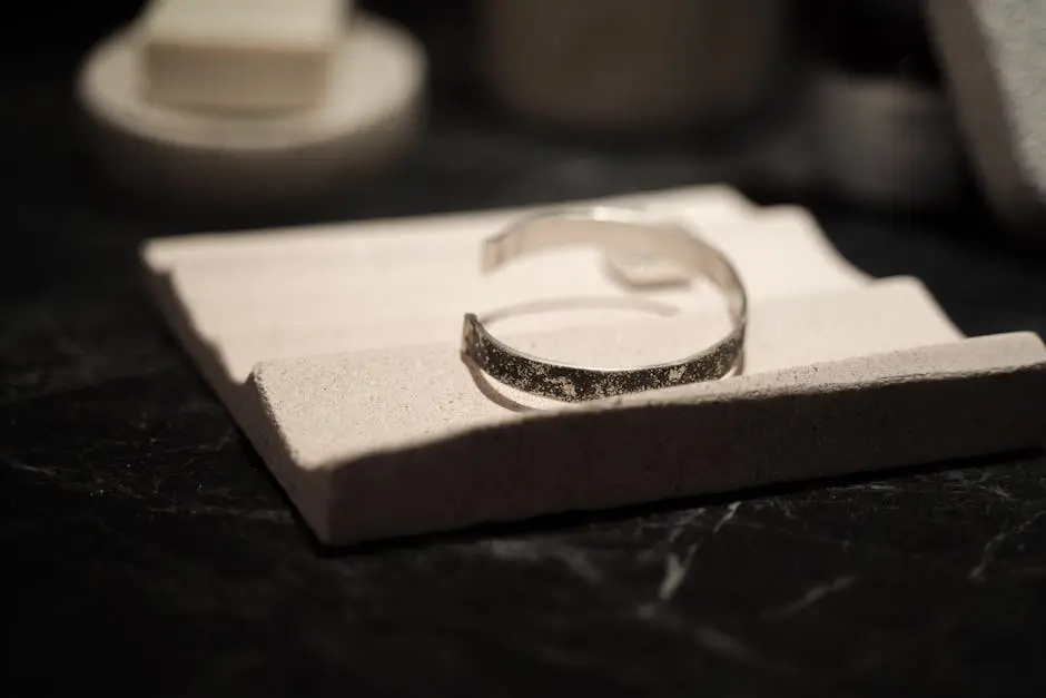 Stylish silver bracelet elegantly displayed on a textured stone surface, perfect for highlighting vintage jewelry.