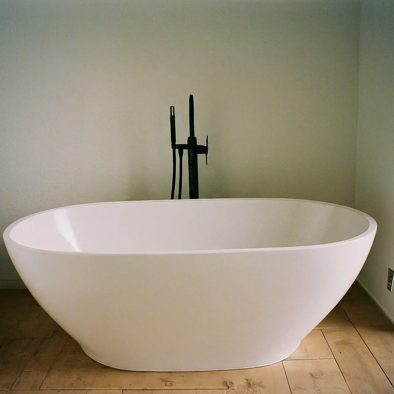 A luxurious white freestanding tub in a modern bathroom. 35mm stock photo