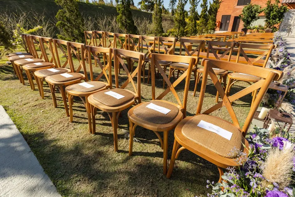 Rows of wooden chairs arranged outdoors at a wedding venue, set for a ceremony.