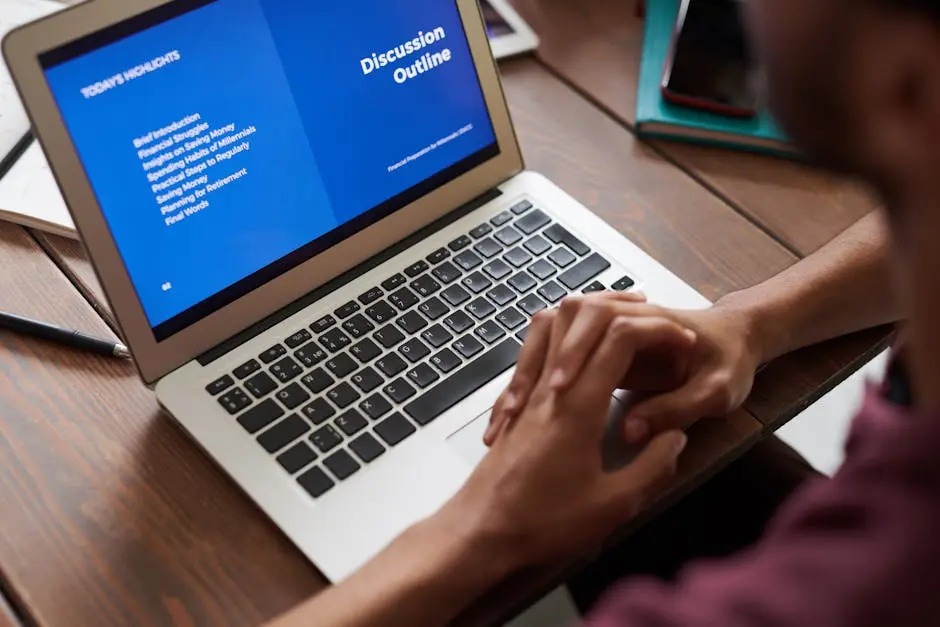 A person viewing a business presentation on a laptop screen, ideal for online learning and work settings.