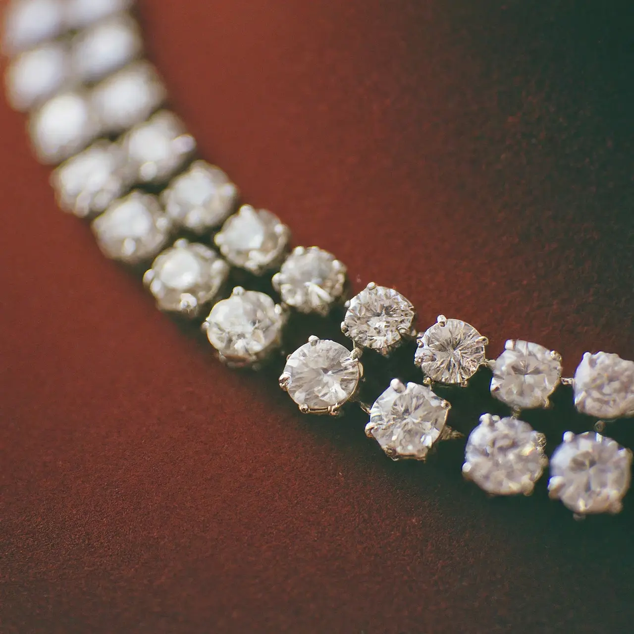 A close-up of a sparkling diamond necklace on velvet. 35mm stock photo