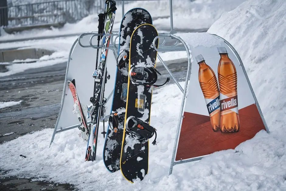 Snowboards and skis in a snowy setting, perfect for winter sports enthusiasts.