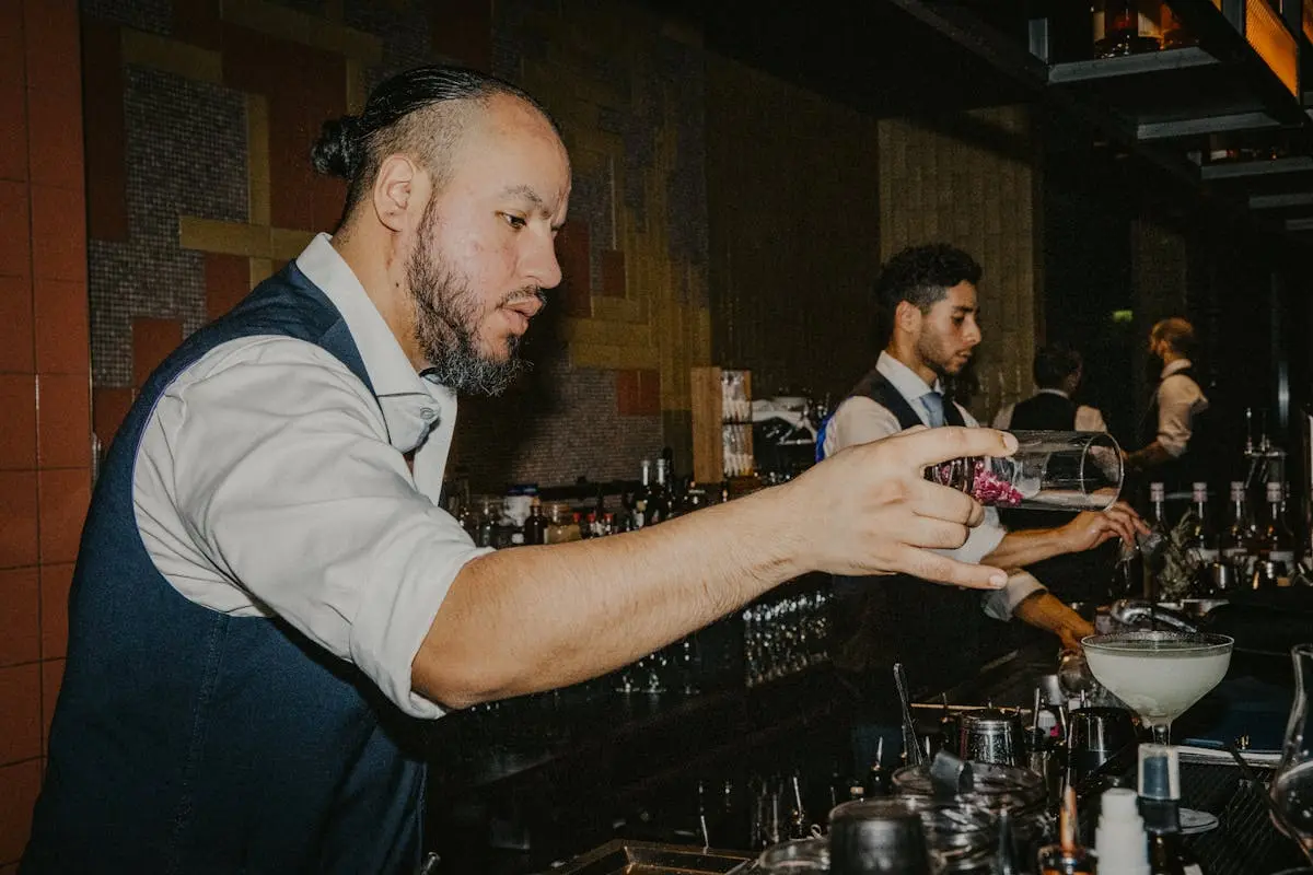 Experienced bartenders create cocktails in a stylish Berlin bar, setting an exclusive nightlife ambiance.