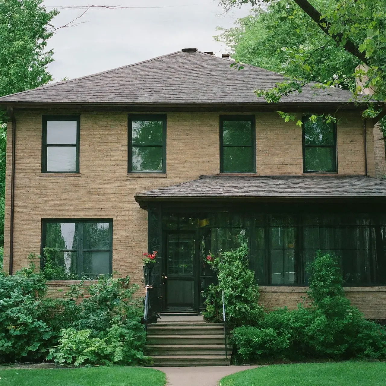 A tidy Minneapolis home exterior surrounded by vibrant greenery. 35mm stock photo