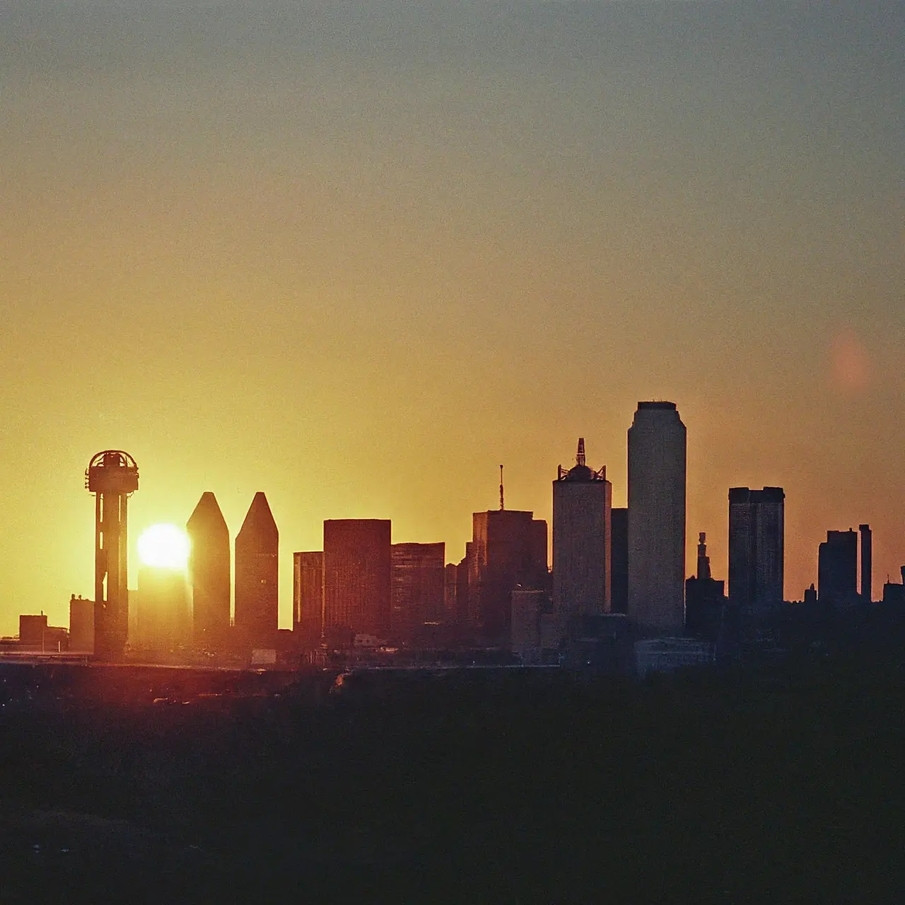 A serene sun setting behind the Dallas skyline. 35mm stock photo