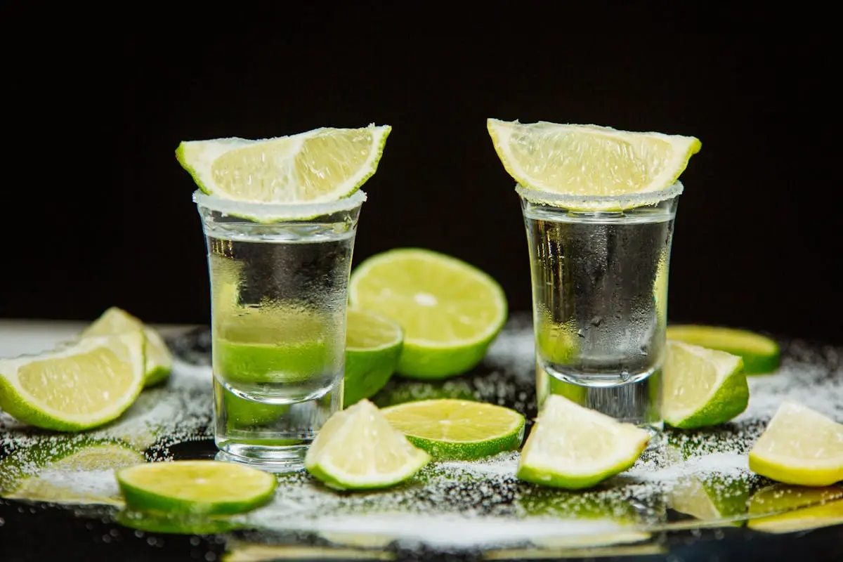 Tequila Drink with Slices of Lime on the Top of Shot Glass