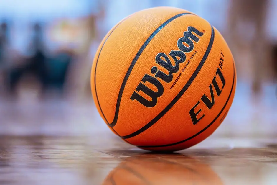 Orange basketball on a polished indoor gym floor, ready for play.