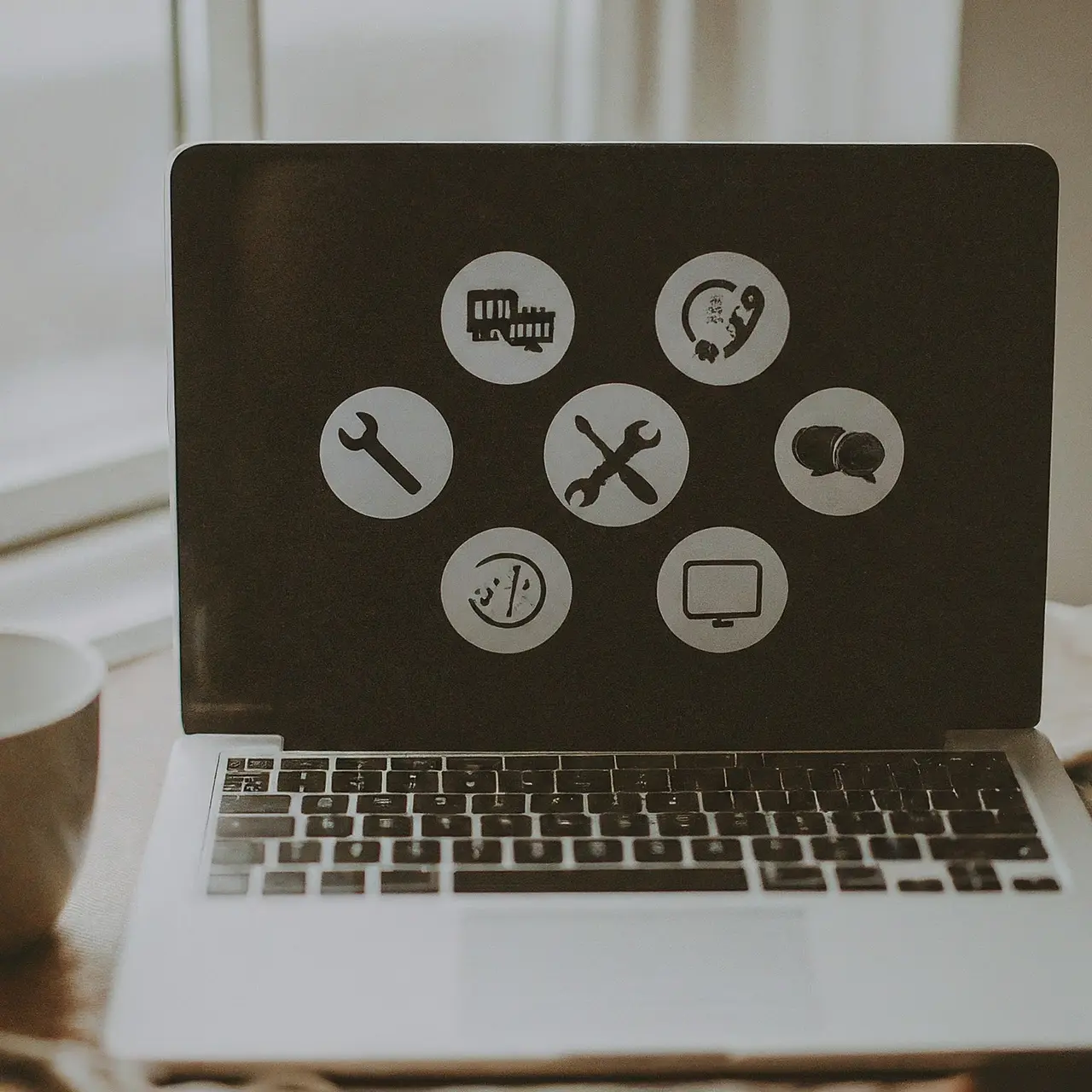 A close-up of a laptop with technical support icons on screen. 35mm stock photo