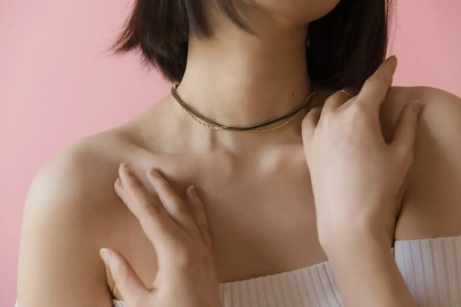 Close-up of a woman’s neck and shoulders, adorned with a choker necklace.