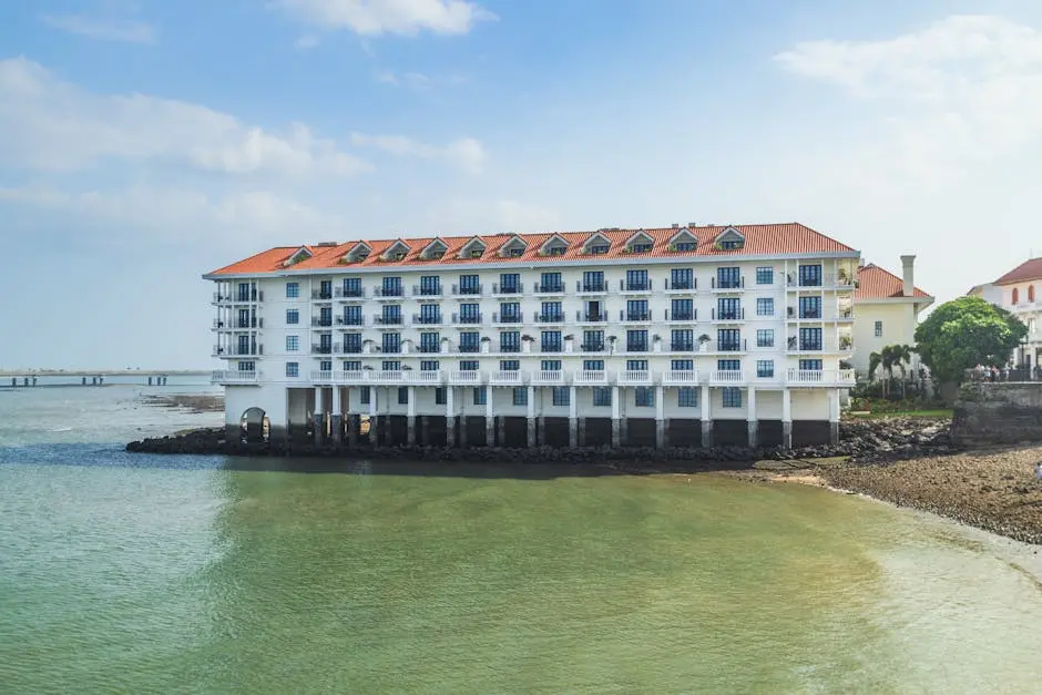 A hotel on the beach next to the water