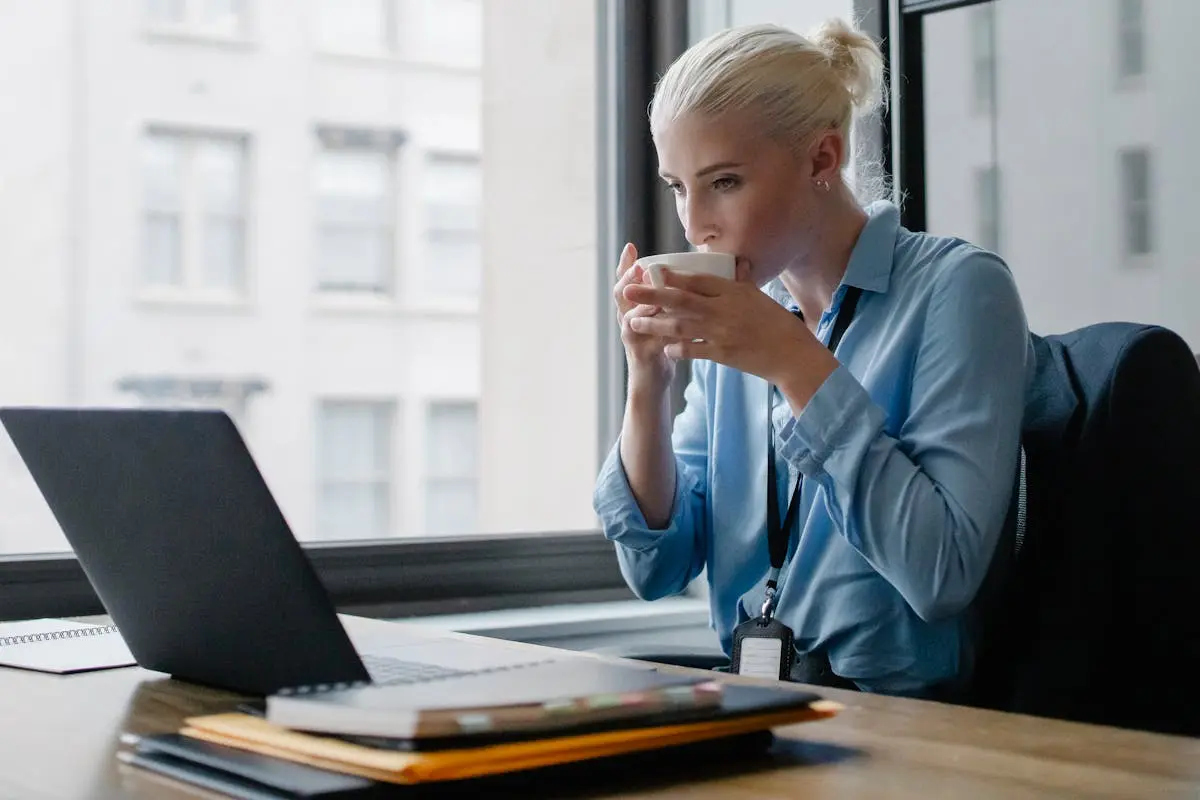 Female manager drinking coffee at workplace