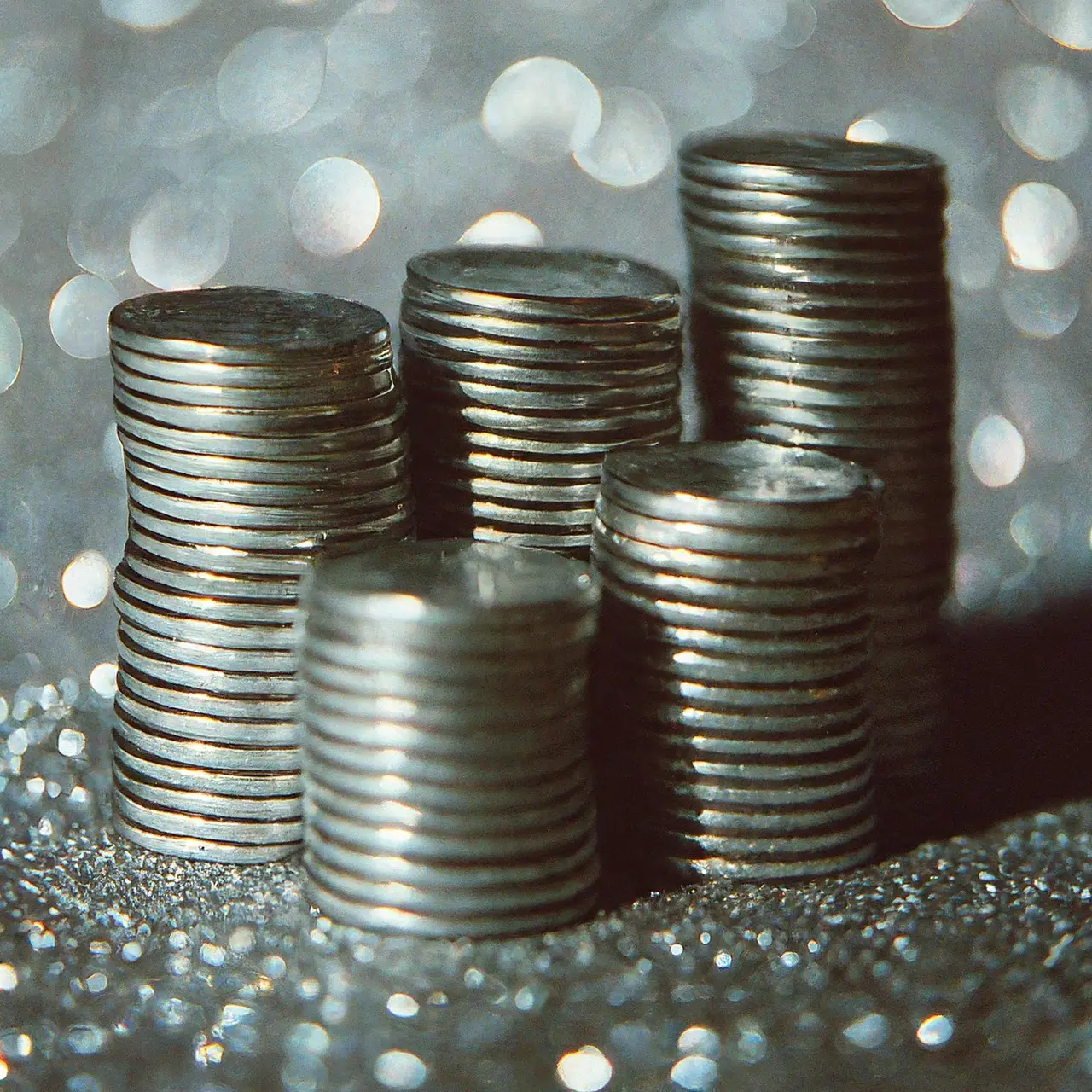 Piles of silver notes against a sparkling background. 35mm stock photo