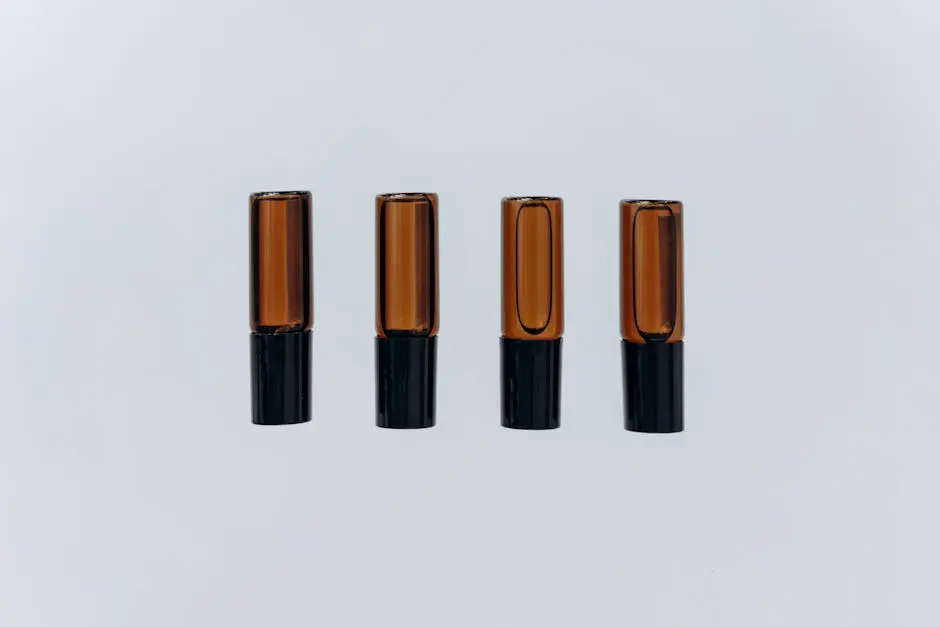 Four amber aromatherapy oil bottles arranged in a simple and elegant composition, showcasing minimalist design.