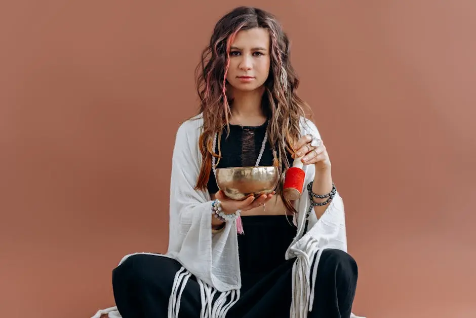 A serene portrait of a woman meditating with a Tibetan singing bowl in a peaceful setting.