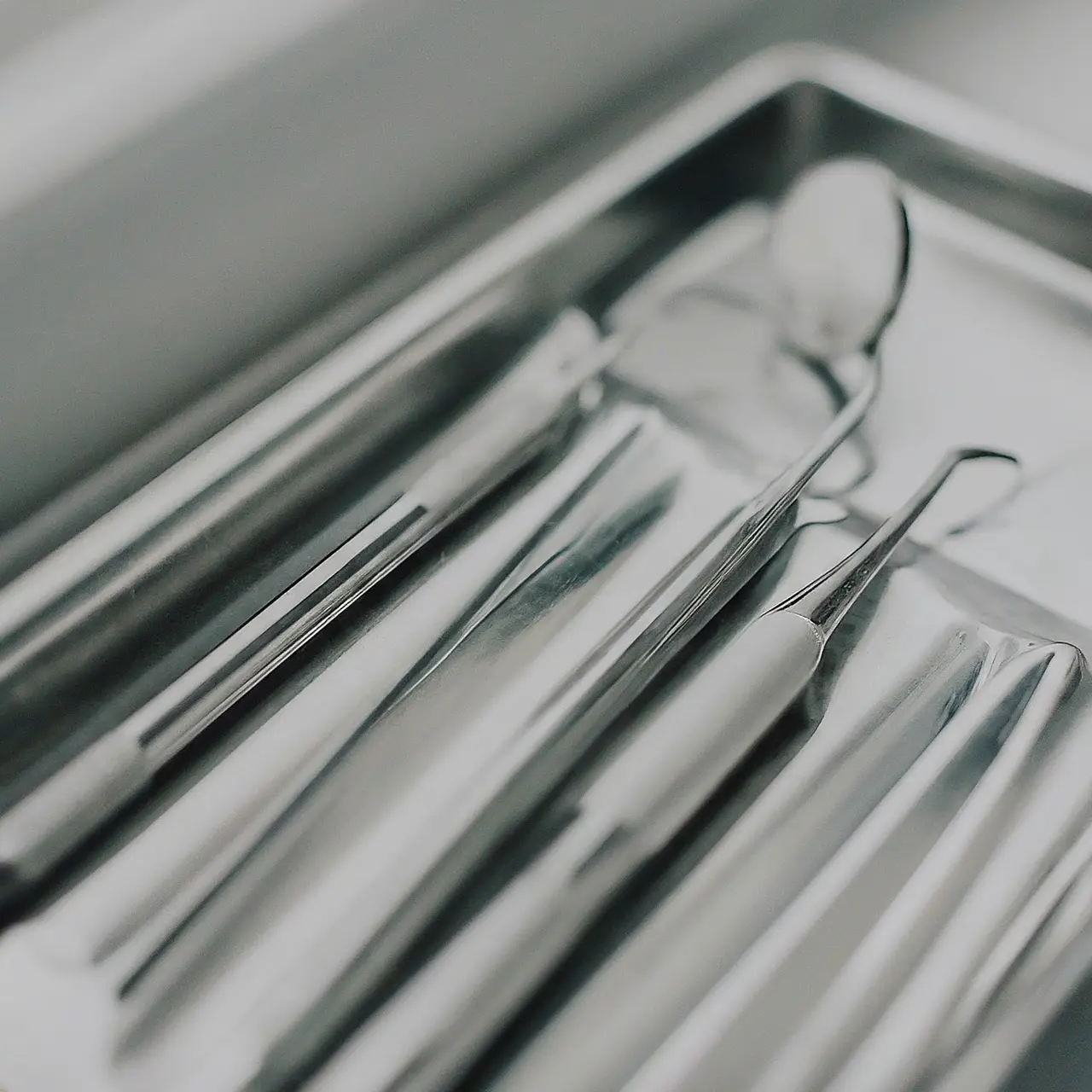 A close-up of dental tools on a clean, white tray. 35mm stock photo