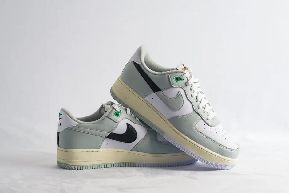 Stylish Nike sneakers with pastel green and black detailing, perfect for a casual look.