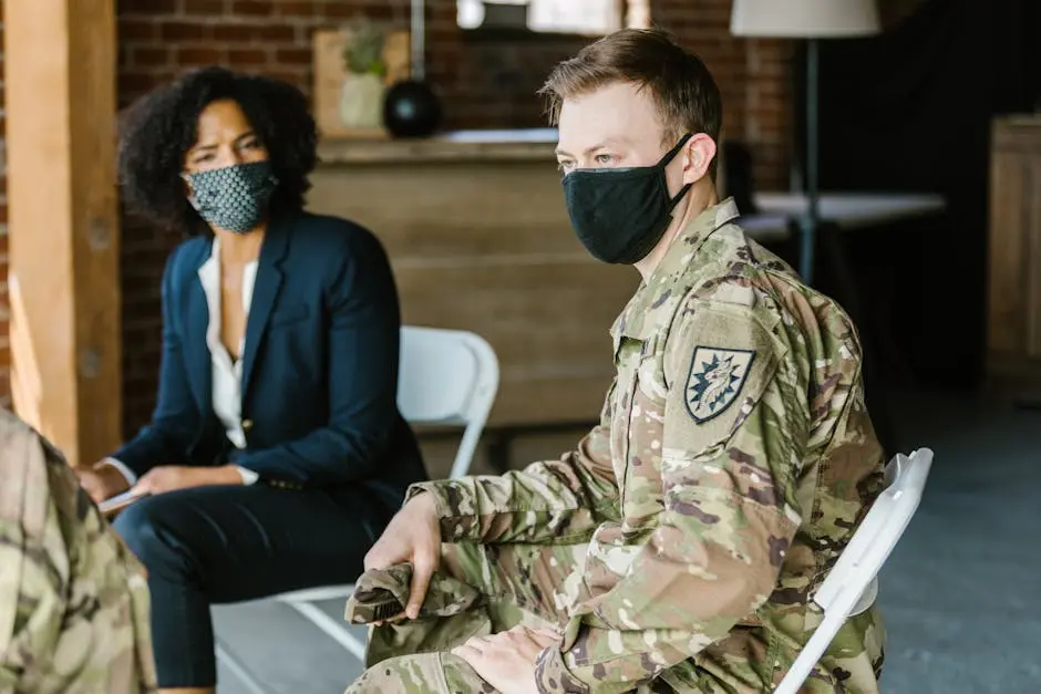 A therapy session with military personnel and a therapist in masks, promoting healing.