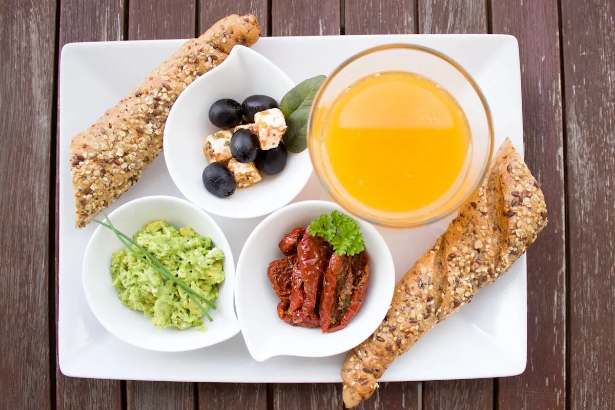 Bread, Juice, and Berries on White Ceramic Plate