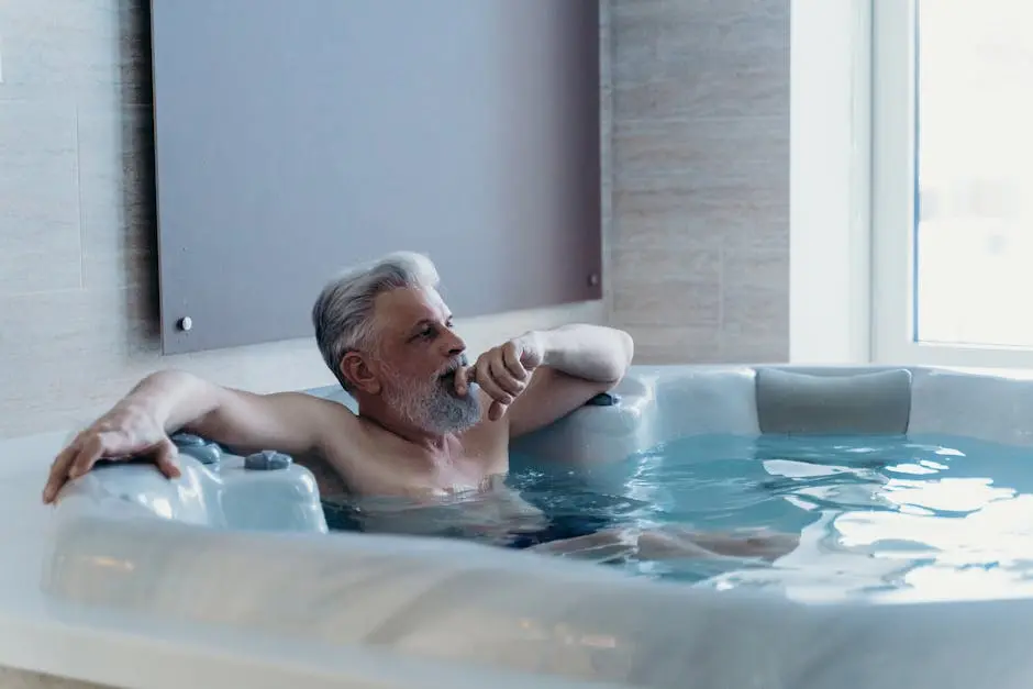 Elderly man enjoying relaxation in an indoor jacuzzi spa setting.