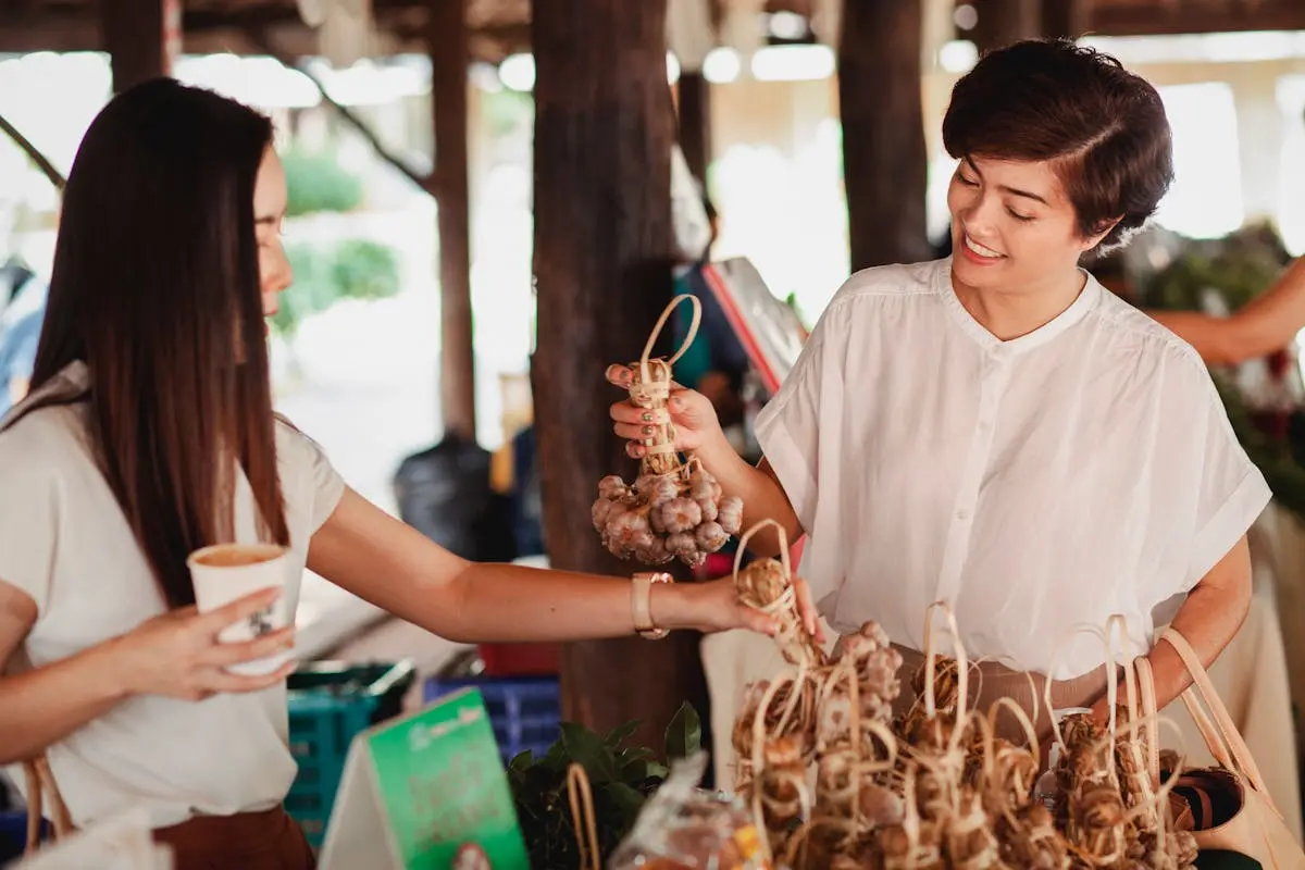 Ethnic women choosing ginseng at street market