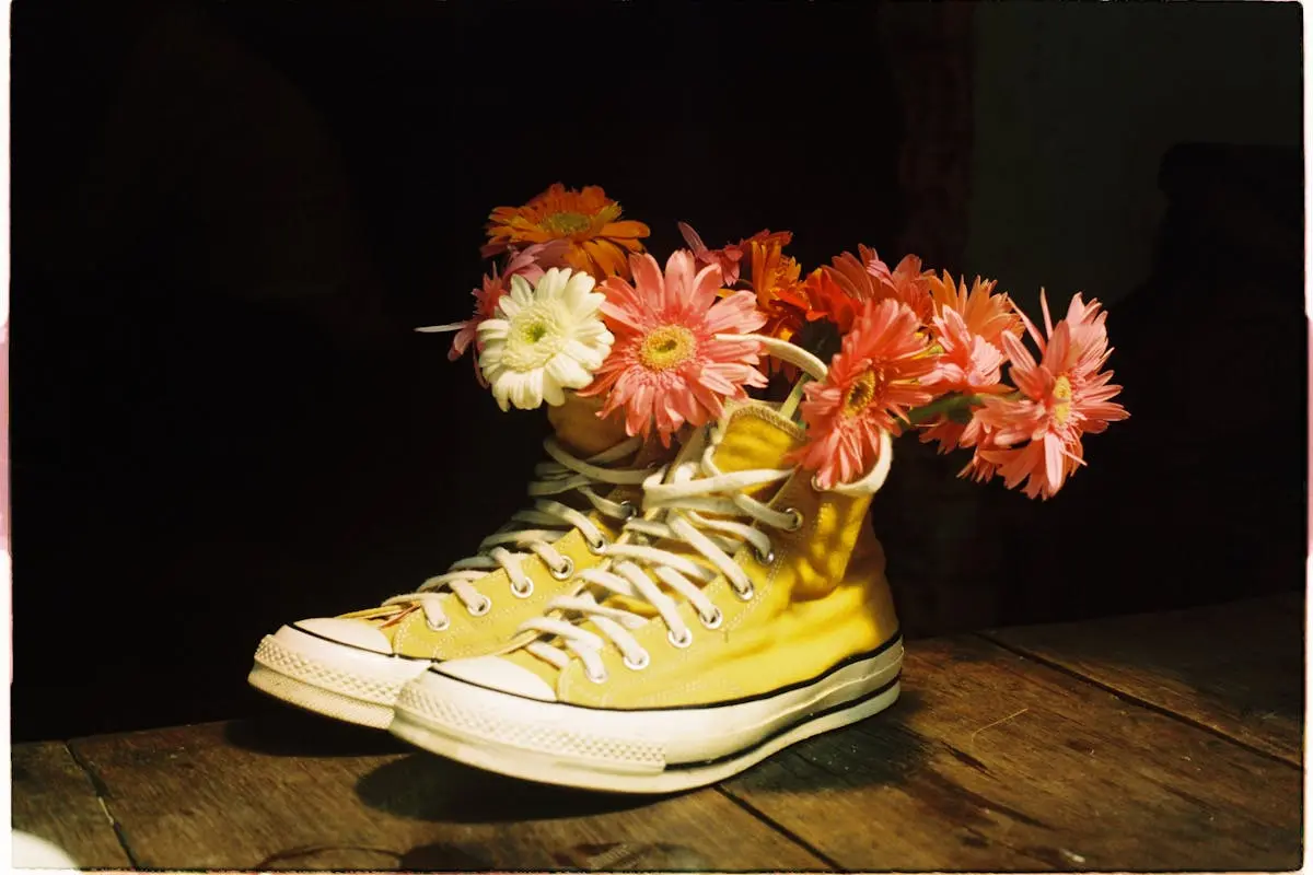 A pair of converse sneakers with flowers in them