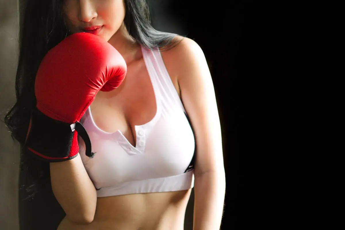 Woman in White Sports Bra and Red Boxing Glove