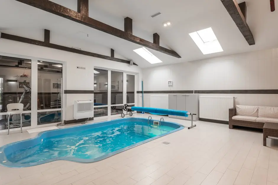 Modern indoor pool area featuring bright lighting and comfortable seating.