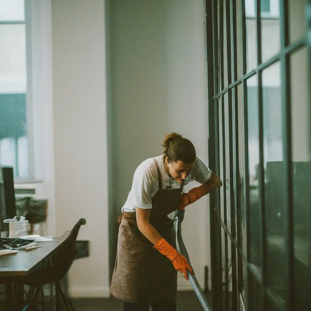 Office being cleaned with modern equipment by professional staff. 35mm stock photo