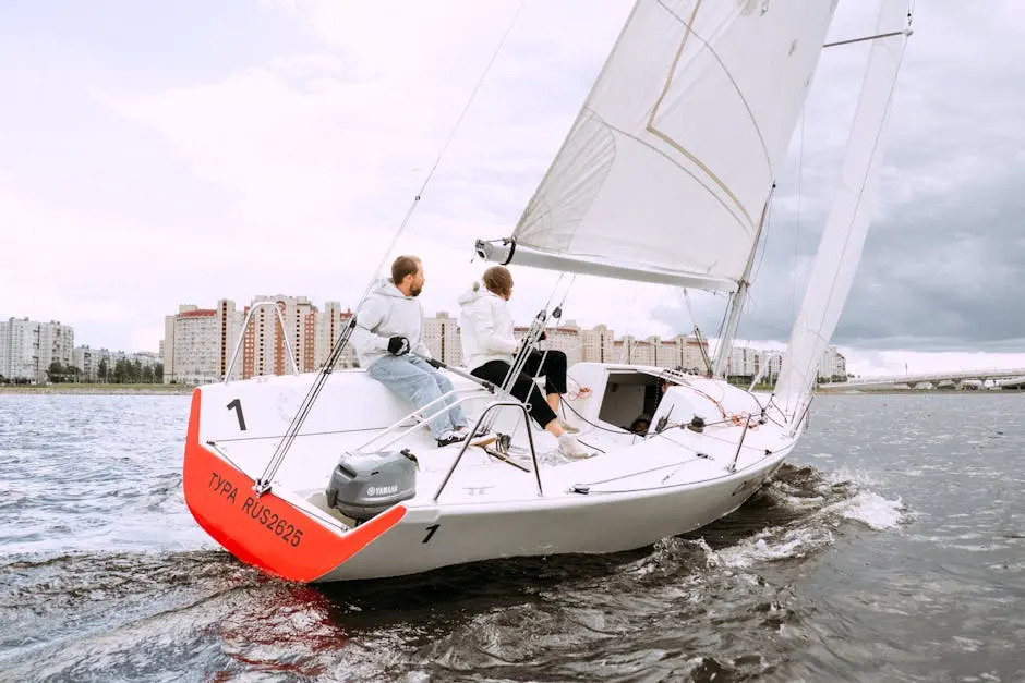 People Riding on Red and White Sail Boat