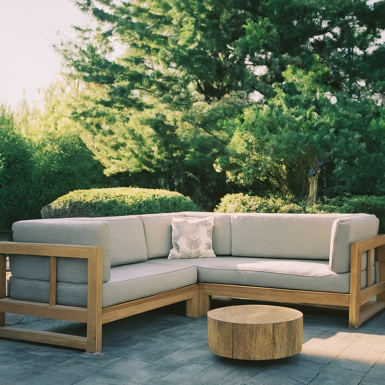 Luxurious outdoor sofa set on a beautifully landscaped patio. 35mm stock photo