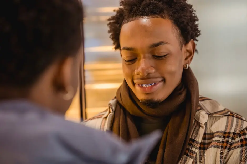 Happy black man with braces talking with friend